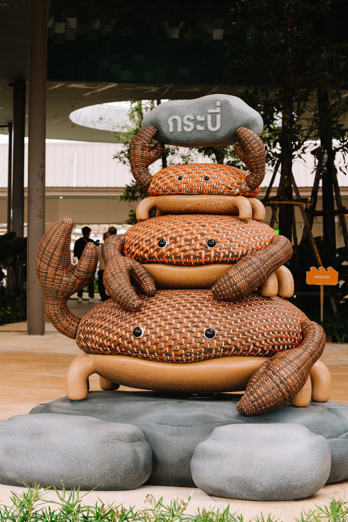 A sculpture of a black crab resting on rocks