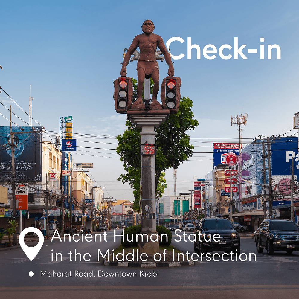 Ancient human statue in the middle of intersection